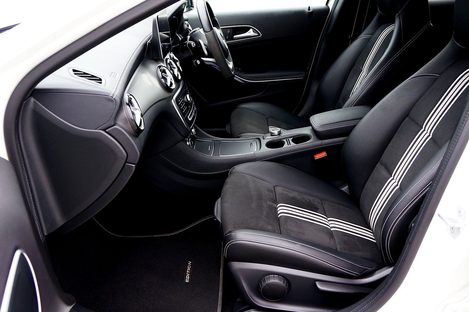 Right-hand-drive Mercedes-Benz interior, viewed from the front passenger side; illustrative stock photograph